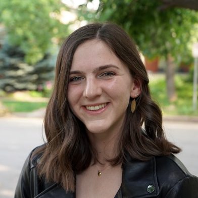 Portrait photo of Anna McTigue. Anna is looking at the camera and smiling