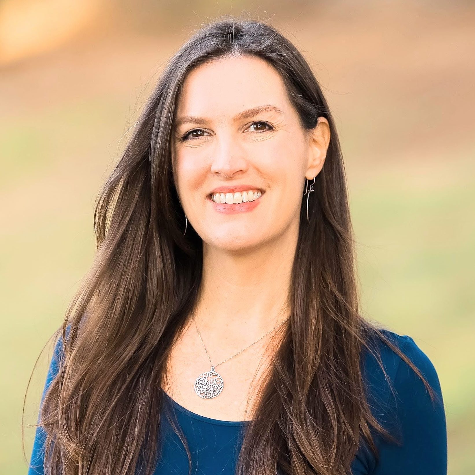 Portrait photo of Kelly. She is looking at the camera and smiling